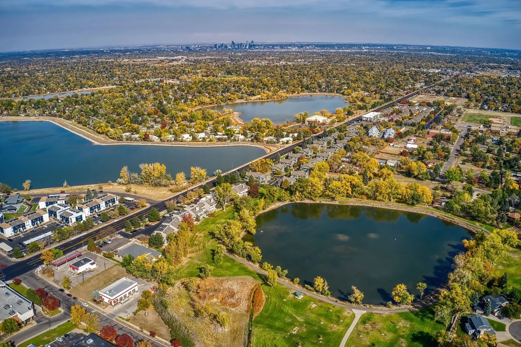Aerial view of Lakewood, Colorado, showing lakes, neighborhoods, and the Front Range foothills.
